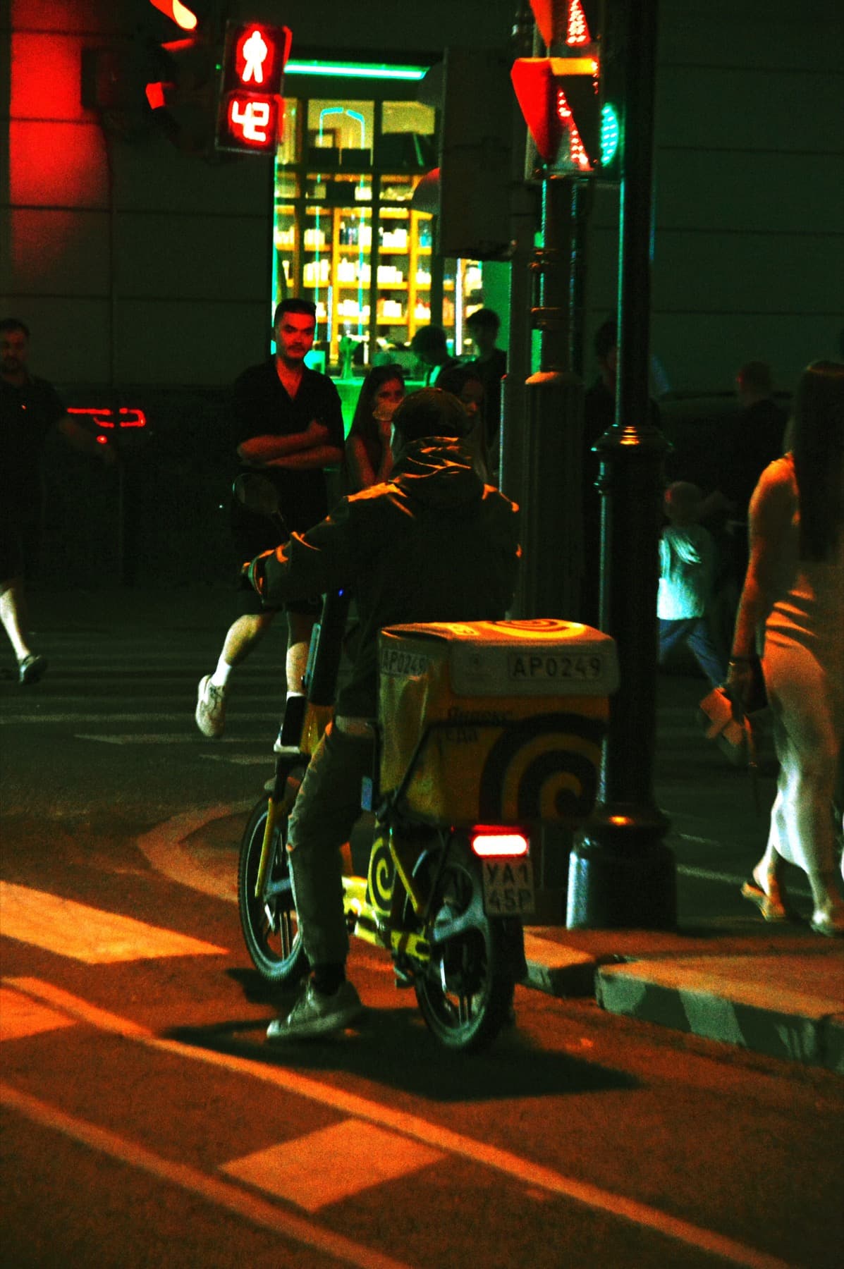 Delivery driver on a scooter at night